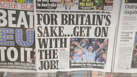 COVID NEWSPAPER HEADLINES ABOUT LOCKDOWN AND PANDEMIC MISTAKES UK 4K Stock Footage 153046500