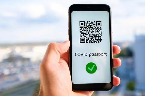 Covid pass with QR code on the screen in smartphone in mans hand on the Foto stock