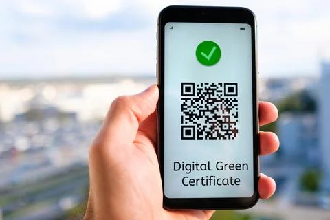 Covid pass with QR code on the screen in smartphone in mans hand on the yellow Stock Photos