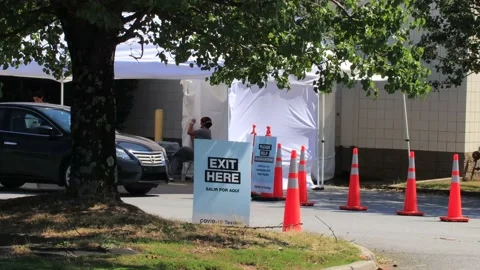 Covid testing site White tent nurses cars and people waiting to get tested Stock Footage