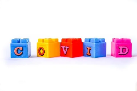 Covid words are arranged in a rustic colorful Lego cube. Suitable for children Stock Photos