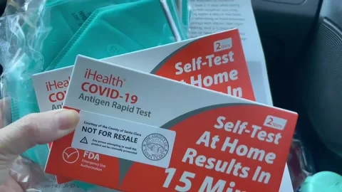 COVID19 Antigen Rapid test kits and N95 masks with instructions. Passenger Stock Footage 169211914