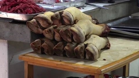 Cow legs on a table with flies in the central market of Huaraz Stock Footage 164577295