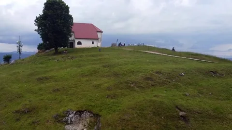 Cow, trail, church, people, view aerial going forward Stock Footage