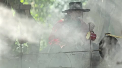 Cowboy are smoking and preparing food around a campfire Stock Footage 326181201