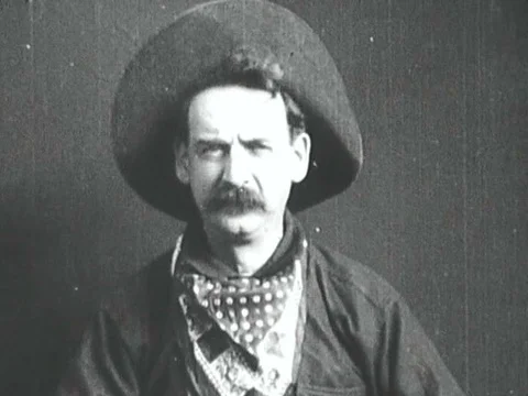 A cowboy fires a gun directly at the camera. Stock Footage 74776563