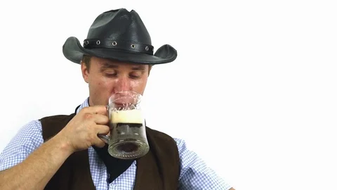 Cowboy in hat drinking beer on a white background Stock Footage 101697307