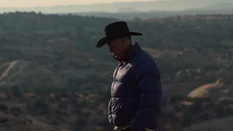 Cowboy hat man exploring the vast desert landscape during sunset Stock Footage 321378592
