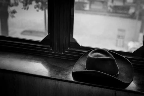 Cowboy hat on windowsill Stock Photos