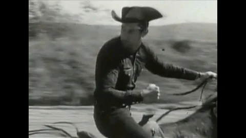 Cowboy horse chase and filming of a stunt in old western movie Stock Footage
