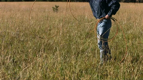 Cowboy practices with lasso, slow motion Stock Footage 61670196