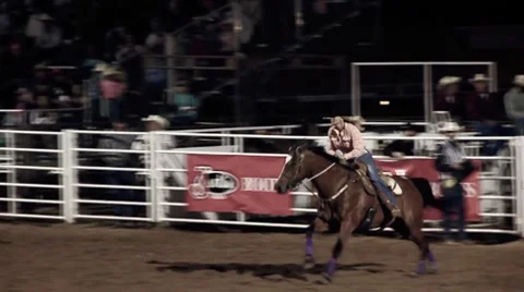 Cowgirl riding horse Stock Footage