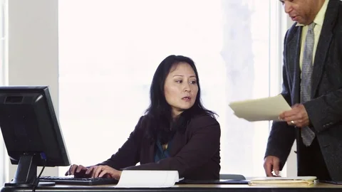 Coworker bringing folder to share with female office worker Stock Footage 80227264