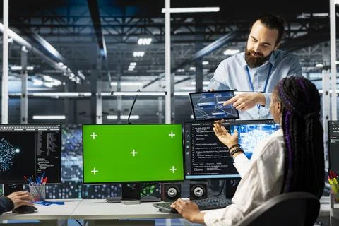 Coworkers coding in data center using green screen mockup PC Stock Photos