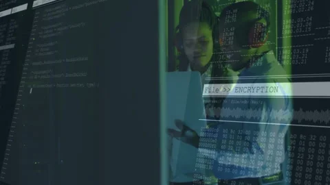 Coworkers collaborating in data center, examining tablet with code overlays and Stock Footage 309105851