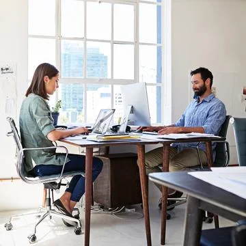 Coworkers, concentration and man and woman in coworking space at creative agency Stock Photos