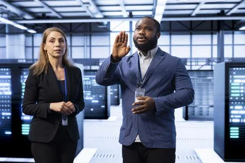 Coworkers in data center checking rigs and hardware, doing checkup with AR tech Stock Photos