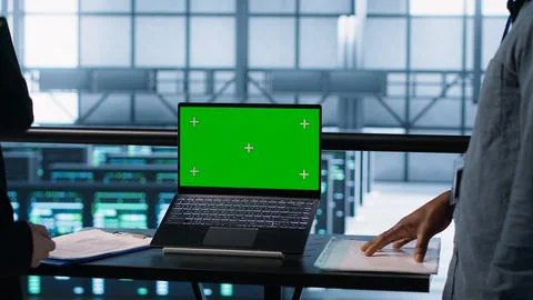Coworkers in data center using mockup laptop, integrating green technologies 写真素材