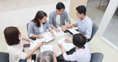 Coworkers discuss at table Stock Footage 146696799