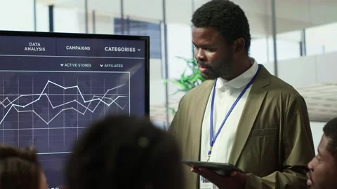 Coworkers engaging in a problem solving meeting at a corporation Stock Footage 318231011