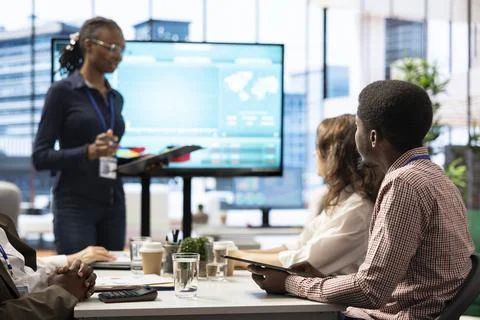 Coworkers engaging in a problem solving meeting at a corporation Foto stock