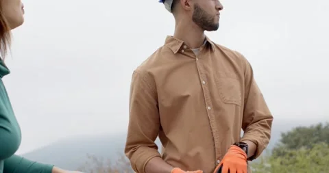 Coworkers lifting rooftop solar panel, man putting on blue hard hat to install, Stock Footage 337886338