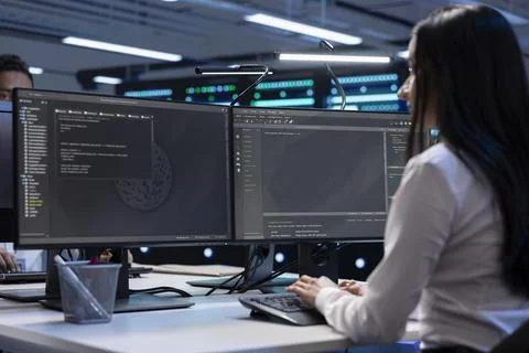 Coworkers looking for network issues affecting server performance Stock Photos
