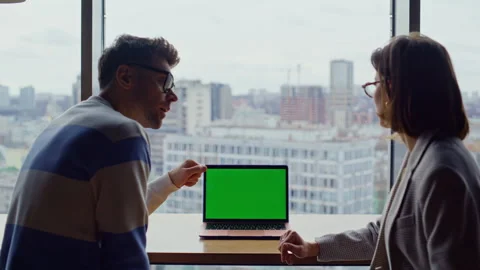 Coworkers pointing mockup computer at windows office closeup. Partners working Stock Footage 335246113