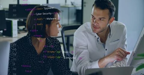 Coworkers reviewing HTML cybersecurity code in open-plan office, with computer Stock Photos