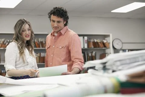 Coworkers reviewing plans Stock Photos