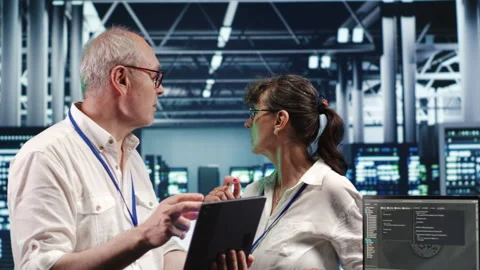 Coworkers running code in data center Stock Footage 249772831