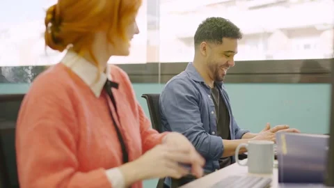 Coworkers smiling while working together with computers Stock Footage 266671113