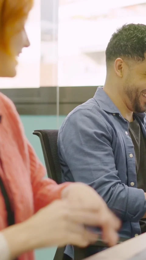 Coworkers smiling while working together with computers Stock Footage 267550112