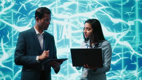 Coworkers solving tasks on laptop and tablet, running AI software Stock Footage 278625744