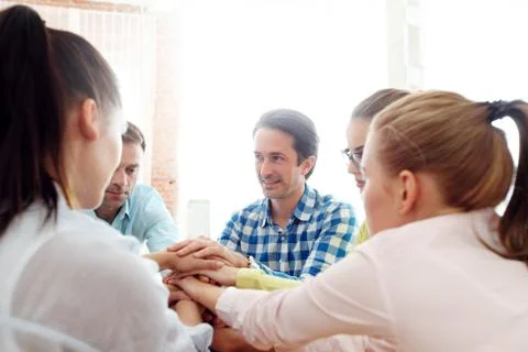 Coworkers stacking hands Stock Photos