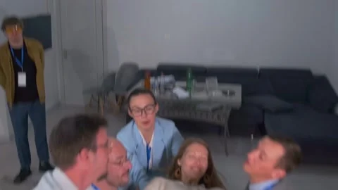 Coworkers support teammate in trust fall team-building activity Stock Footage 316065260