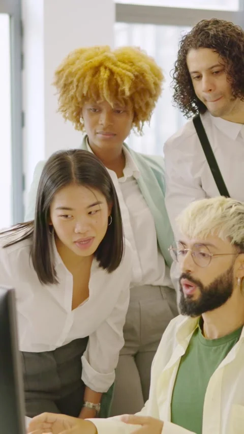 Coworkers talking while looking at a one computer screen Stock Footage 257304861