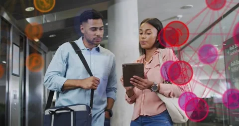 Coworkers tapping tablet screen in lobby, generating animated data network for Stock Footage 320287526