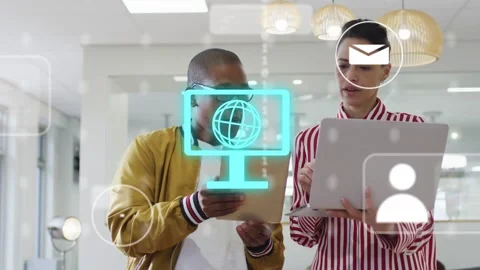 Coworkers in tech examining devices, cyan globe and floating icons appearing Stock Footage 333510087