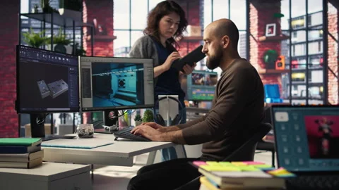 Coworkers using AI chatbot interface to generate video game spaceship Video stock 308606237