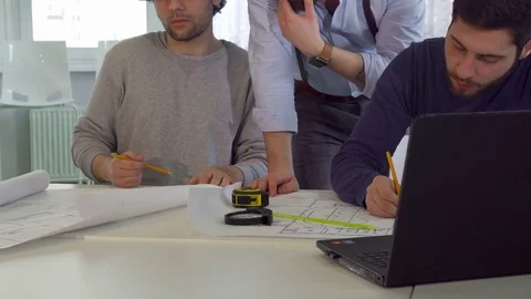 Coworking architects talk at the table Stock Footage 73911558