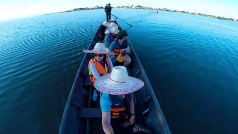 Coxswain steer long tail boat for passenger at Phayao reservoir Stock Footage 79485268