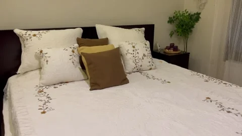 Cozy and Elegantly Made Bed in a Modern Bedroom Video stock 345741150