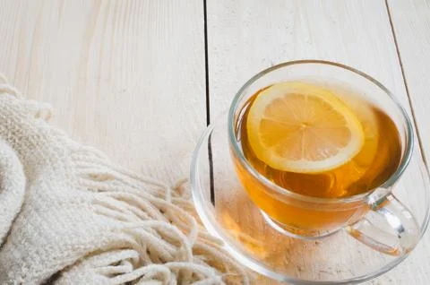 Cozy and soft winter background. Cup of tea and warm knitted blanket. 스톡 사진