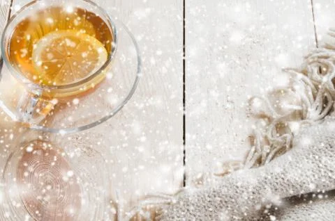 Cozy and soft winter background. Cup of tea and warm knitted blanket. Stock-Fotos