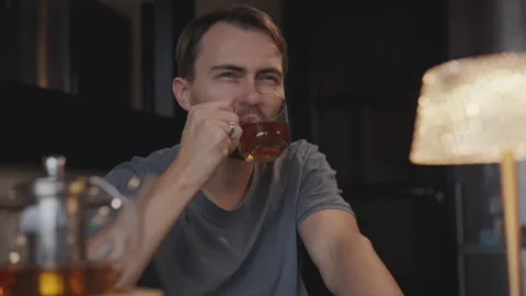 Cozy atmosphere man drink tea at a table Stock Footage 295171474