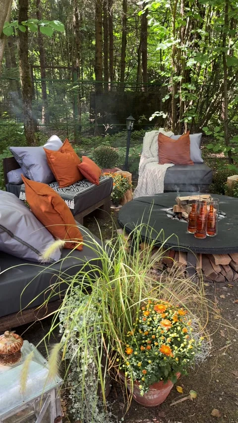 Cozy autumn fire pit area with outdoor seating in woodland garden Video stock 342647064