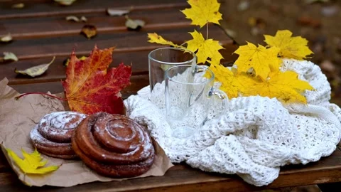 Cozy autumn scene with empty cups, pastries and plaid on bench 스톡 동영상 318672617