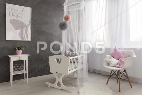 A cozy baby girl room with a big window Stock Photos