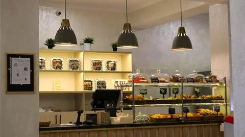 Cozy bakery interior with a display case of pastries Stock Photos